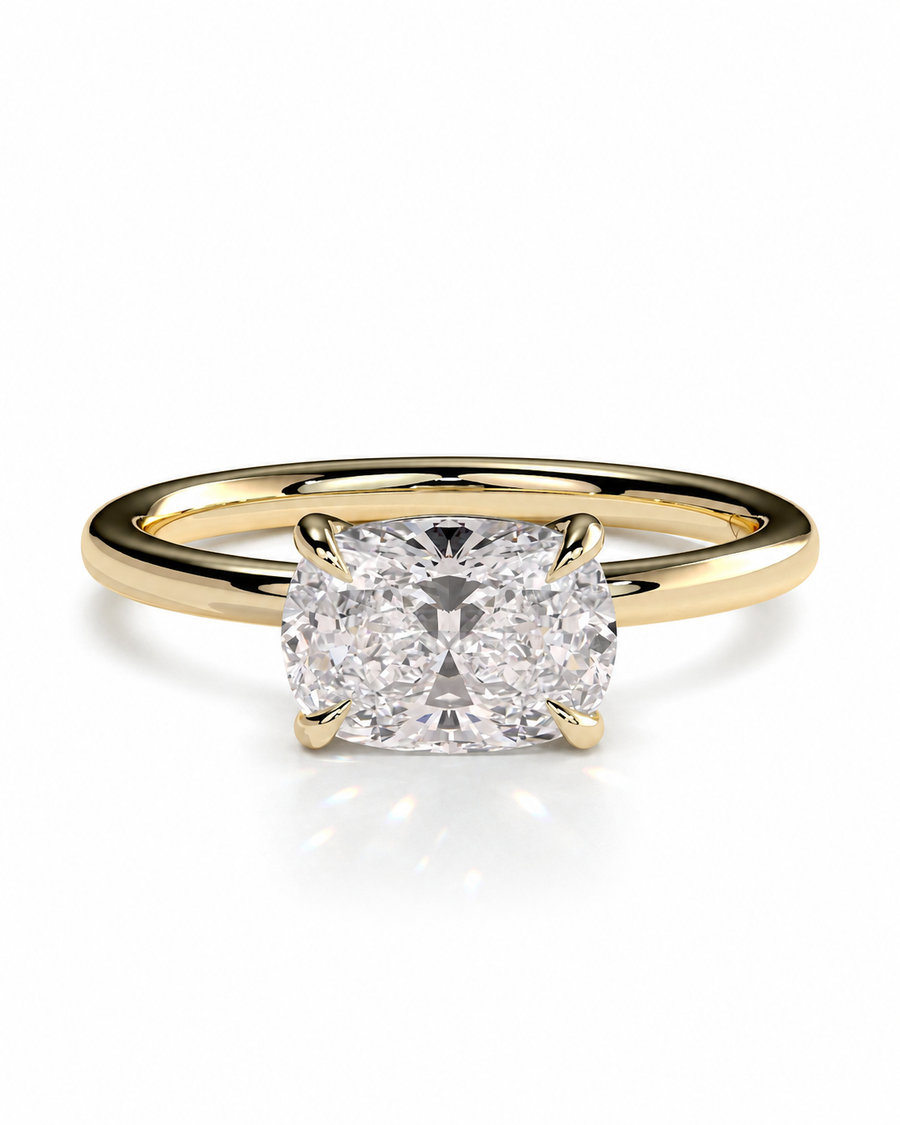 color_10K_YG, color_14K_YG &&A yellow gold solitaire engagement ring featuring a cushion-cut diamond center stone in a four-prong setting, shown on a clean white background with a soft reflection.