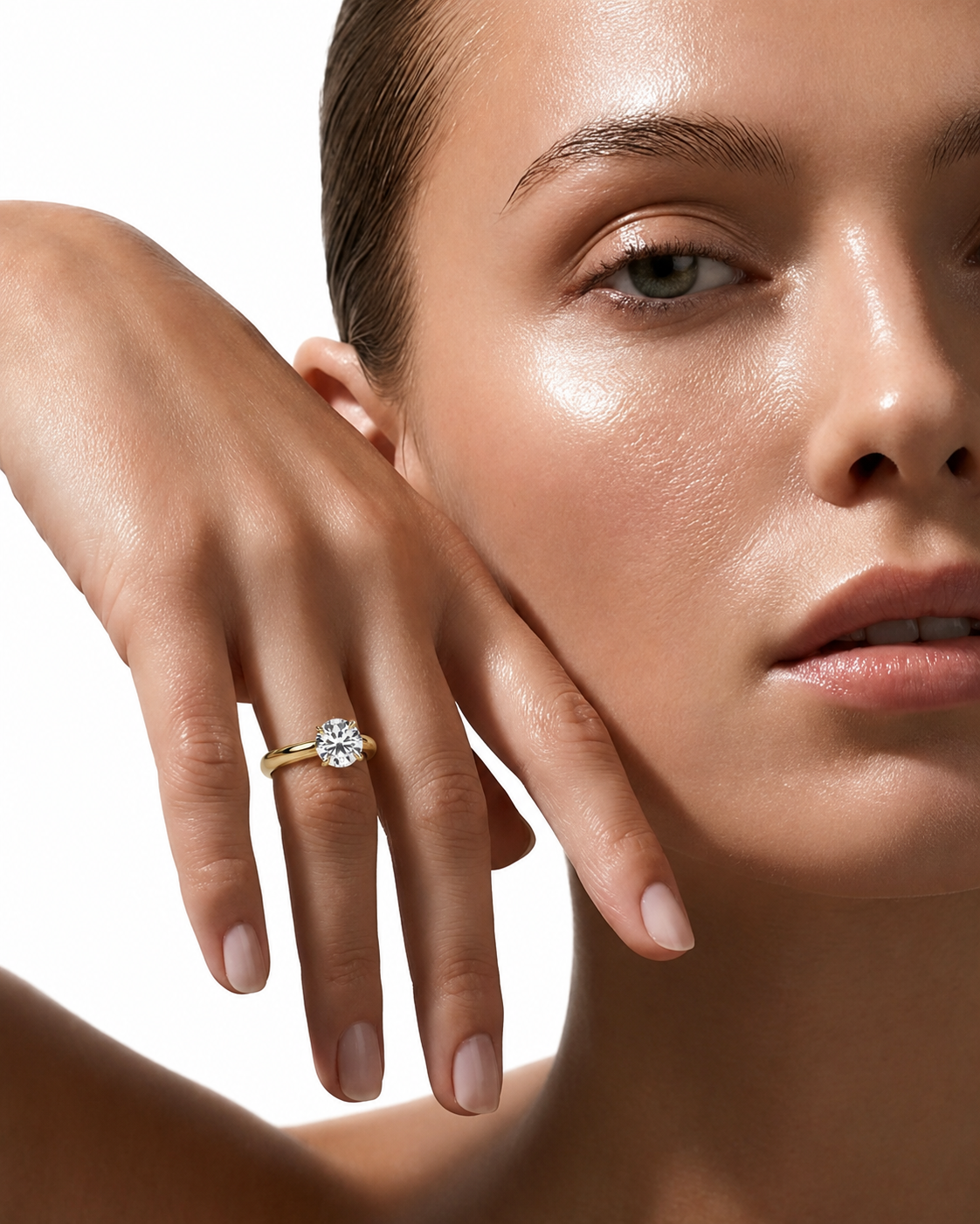 color_10K_YG, color_14K_YG &&A close-up lifestyle shot of a model wearing a yellow gold diamond engagement ring on her finger, with her hand resting against her cheek against a clean white background.