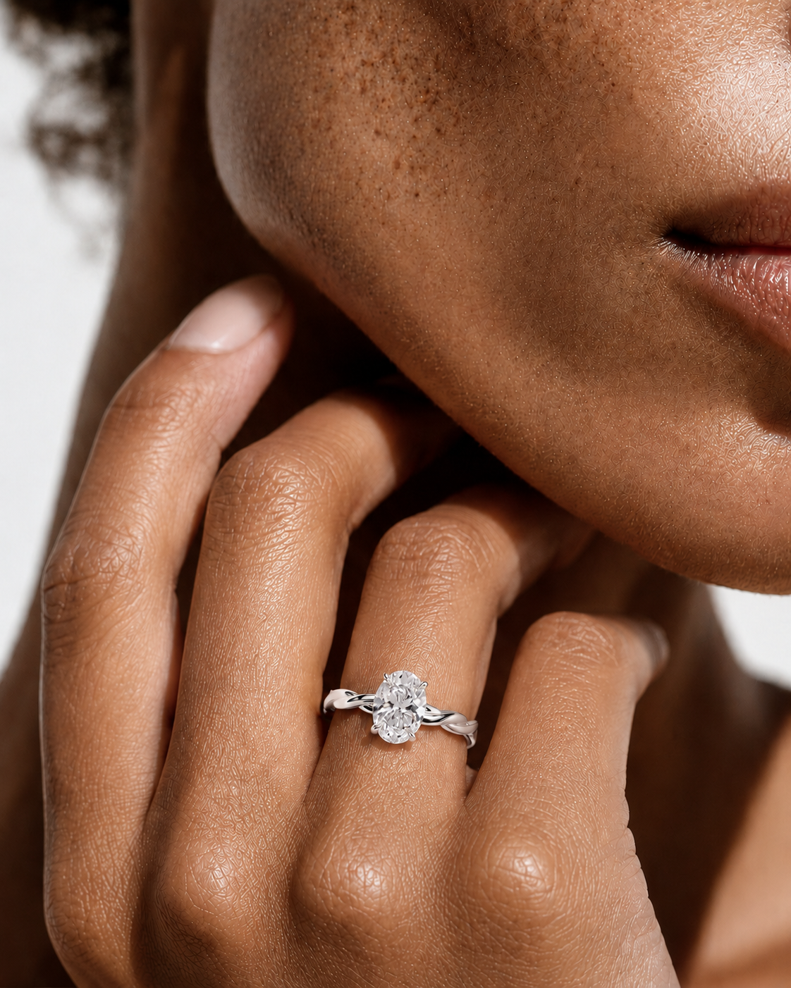 color_925_SIL,color_935_ARG,color_10K_WG, color_14K_WG &&
A close-up lifestyle shot of a model's hand wearing a silver-toned diamond ring with a four-stone diamond cluster setting.
