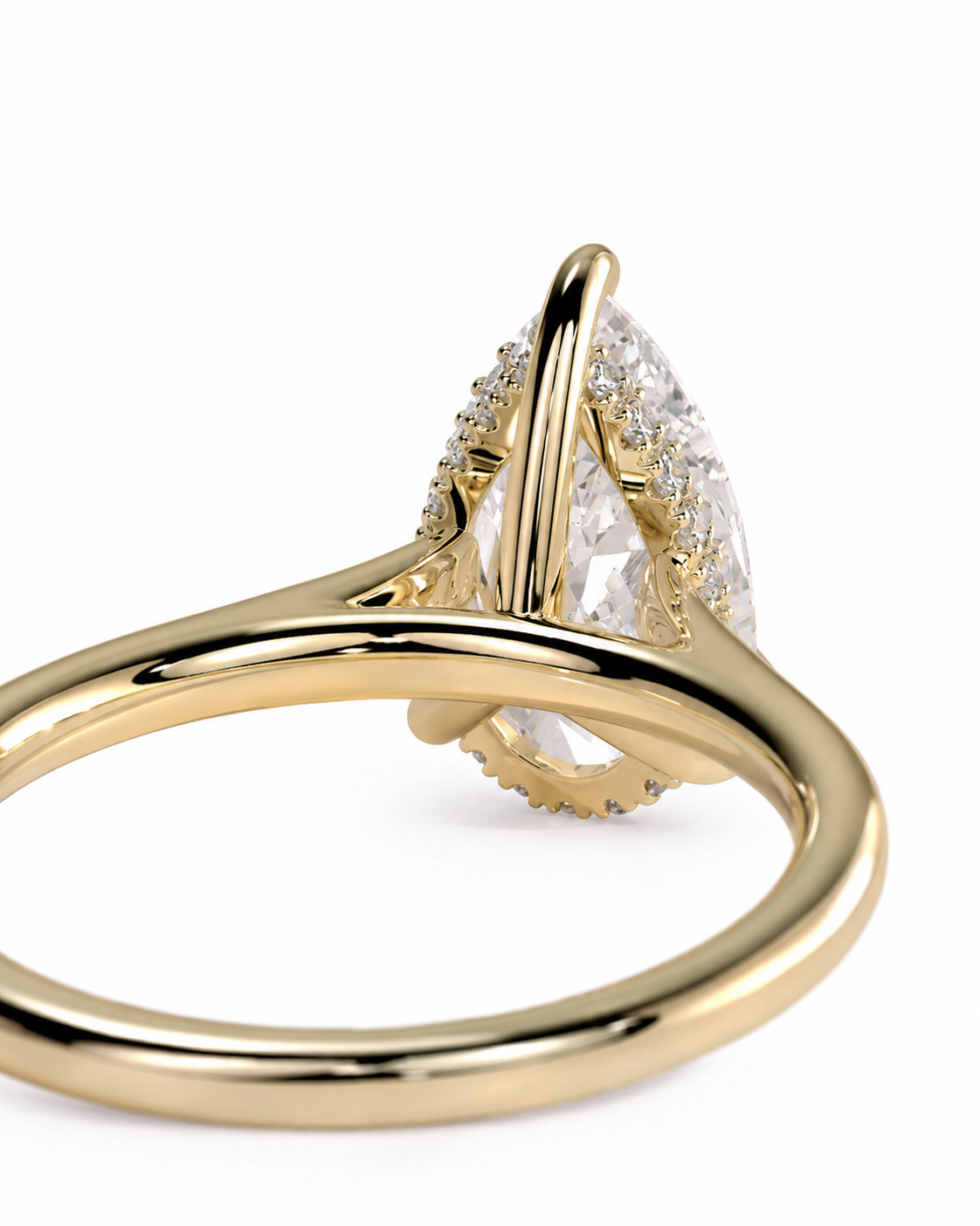 color_10K_YG, color_14K_YG &&A close-up shot of a gold ring featuring a large pear-cut clear center stone surrounded by small pavé-set diamonds, on a clean white background.