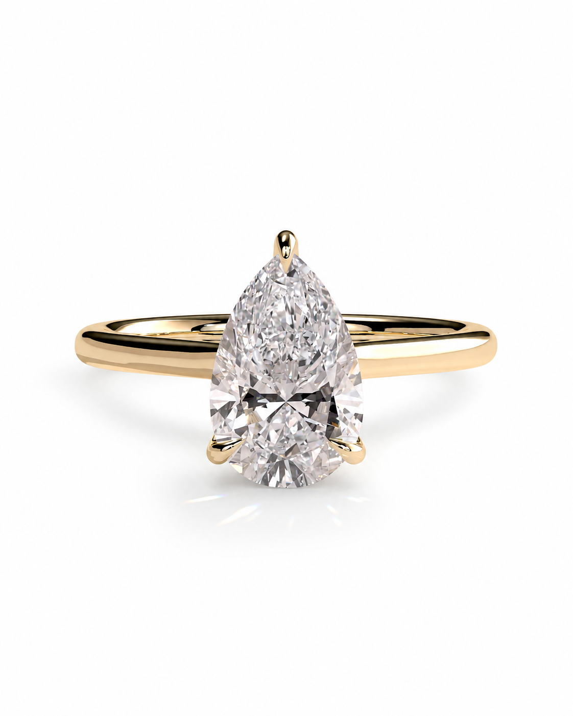 color_10K_YG, color_14K_YG &&A pear-cut diamond solitaire engagement ring set in a yellow gold band, shown on a clean white background with a soft reflection.