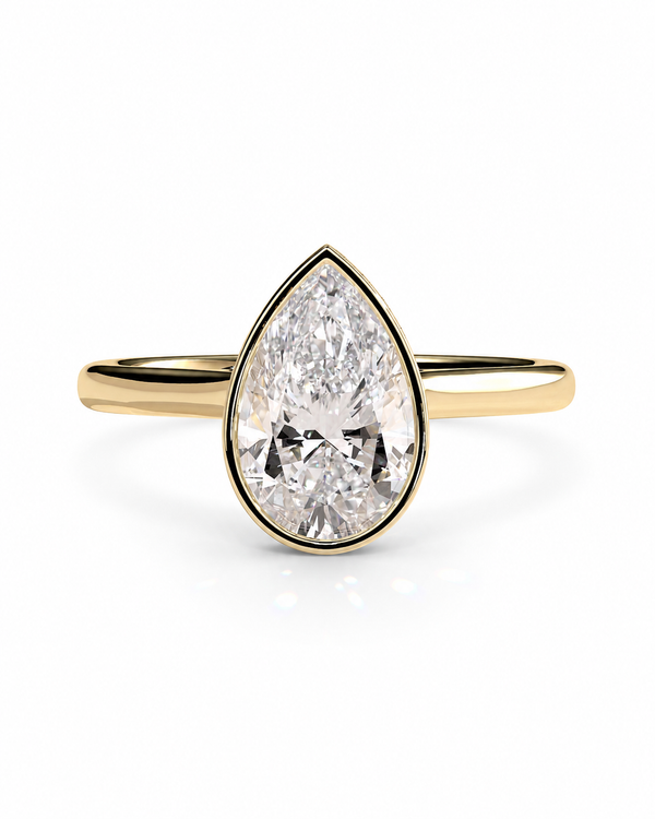 color_10K_YG, color_14K_YG &&A pear-cut diamond engagement ring in a yellow gold setting and band, shown on a clean white background.