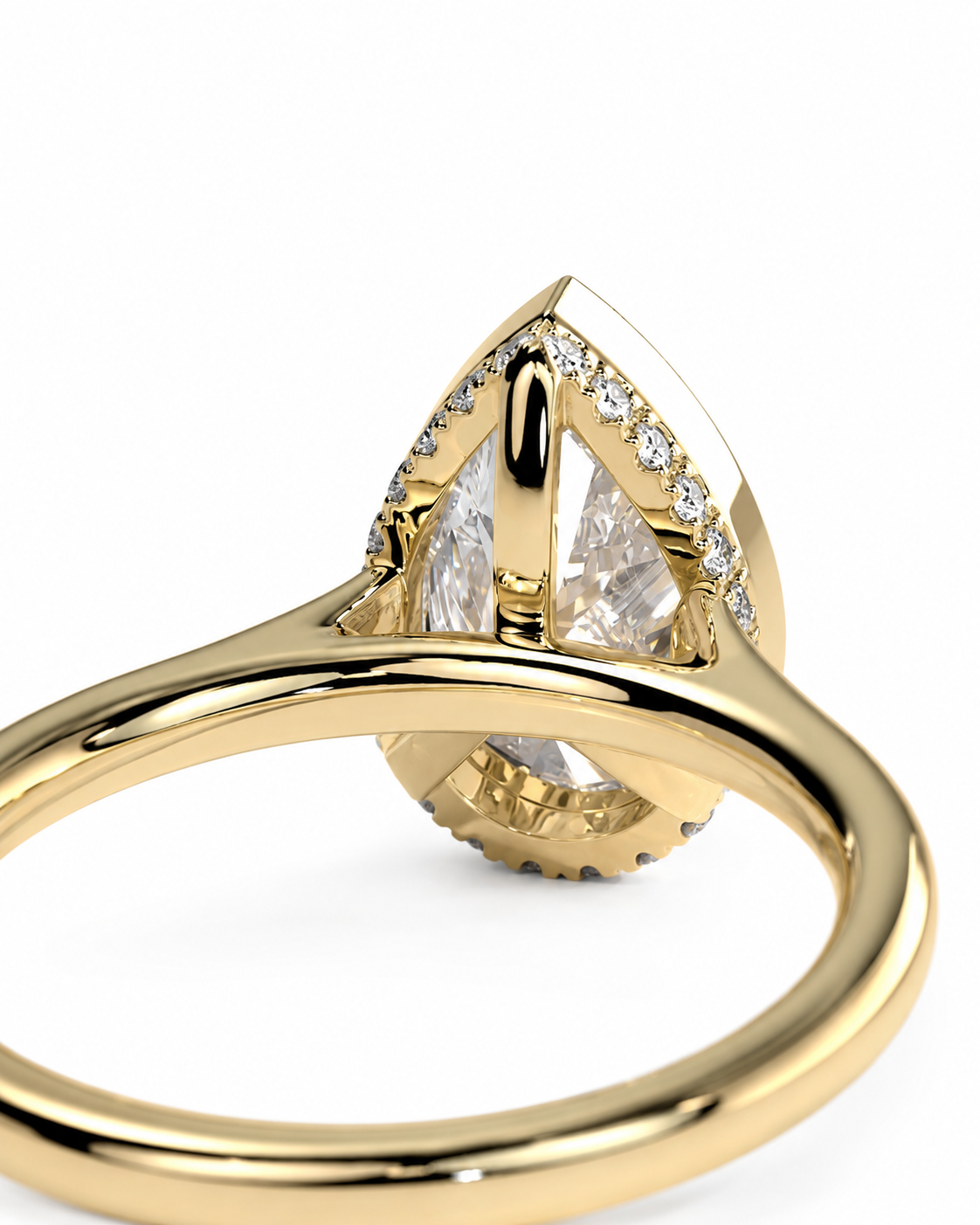 color_10K_YG, color_14K_YG &&A close-up of a gold ring featuring a large pear-cut clear center stone with smaller clear stones along the shoulders, set in polished yellow gold on a white background.