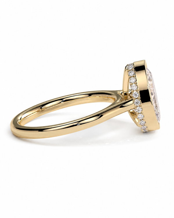 color_10K_YG, color_14K_YG &&A yellow gold ring with a halo setting and a round center stone, accented by small clear stones along the band, shown on a white background.