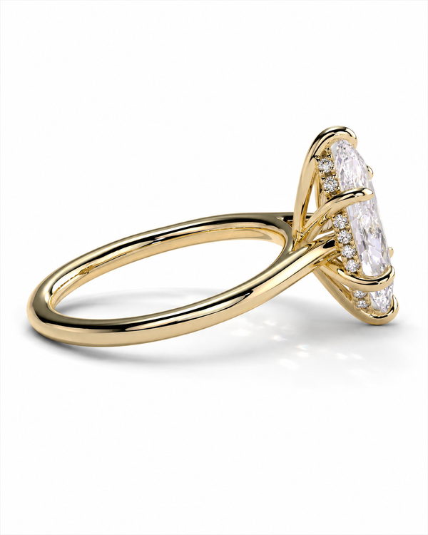 color_10K_YG, color_14K_YG &&A yellow gold ring featuring a large marquise-cut clear gemstone in a prong setting, accented by smaller round and baguette-cut stones along the shoulders, shown on a clean white background.