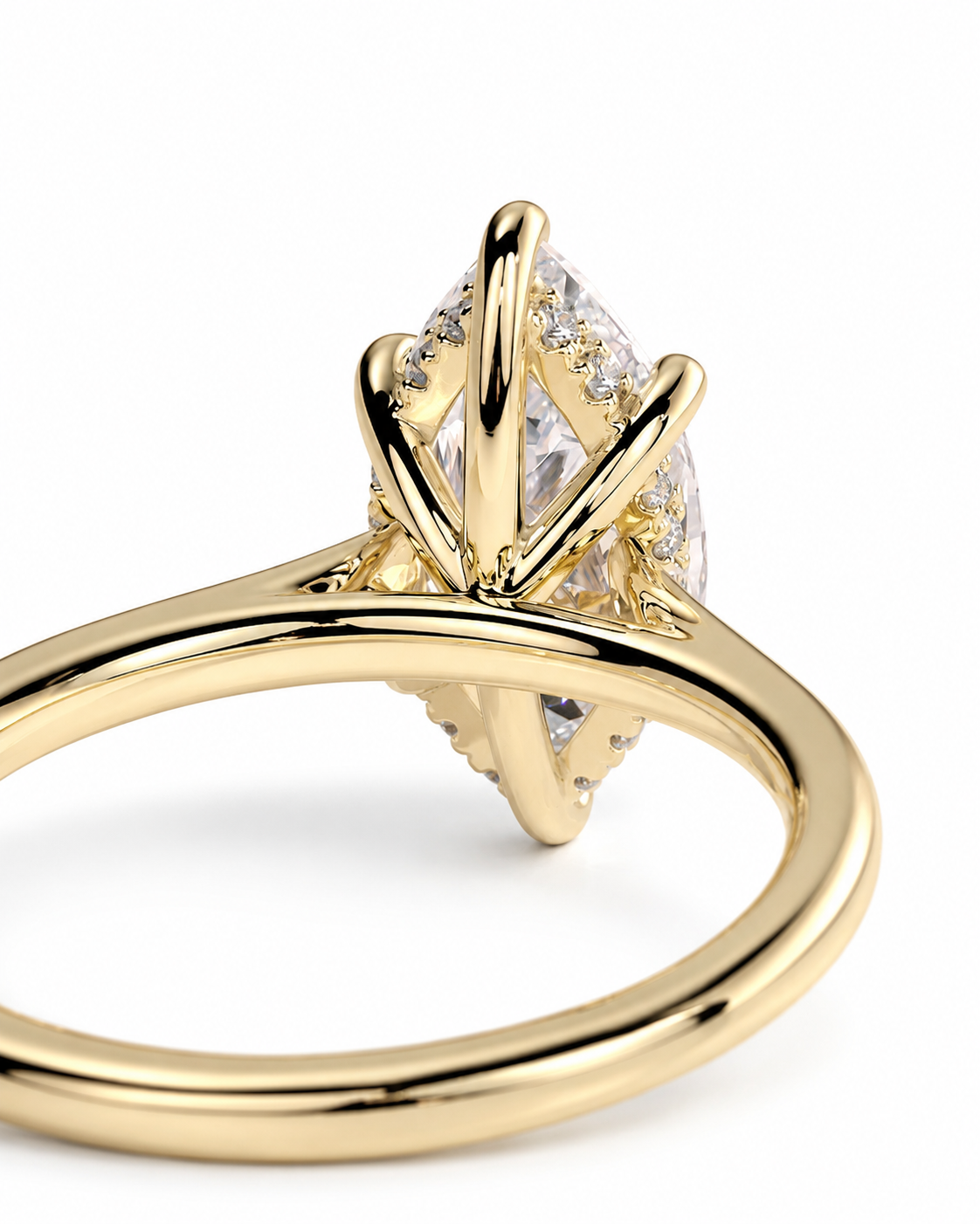 color_10K_YG, color_14K_YG &&A close-up shot of a yellow gold ring featuring a marquise-cut clear gemstone in a prong setting, with small accent stones along the band, set against a plain white background.