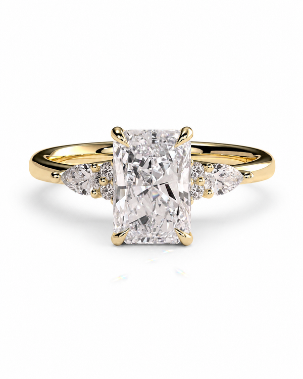 color_10K_YG, color_14K_YG &&A yellow gold engagement ring featuring a large rectangular emerald-cut diamond center stone with smaller round and marquise-cut diamonds on the shoulders, set against a clean white background.