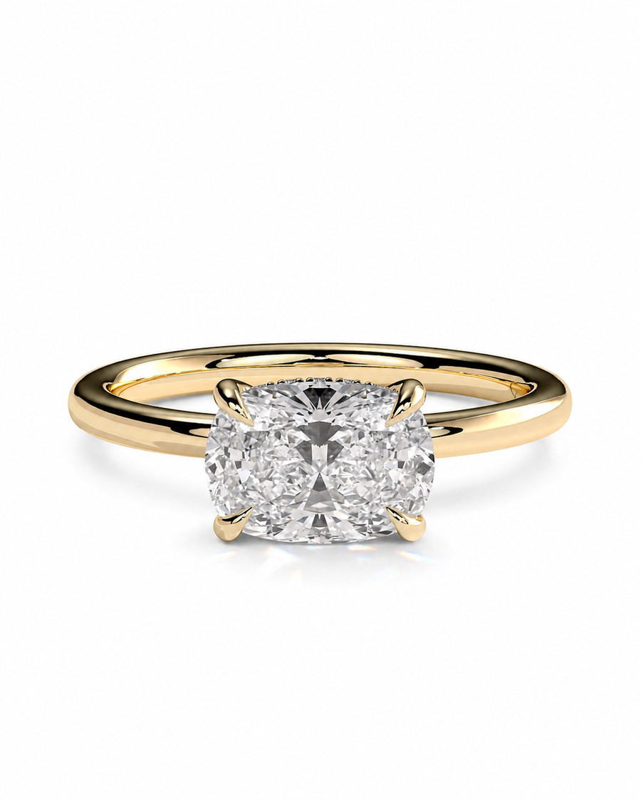 color_10K_YG, color_14K_YG &&A classic solitaire engagement ring featuring a cushion-cut diamond set in a yellow gold four-prong band, shown on a clean white background.