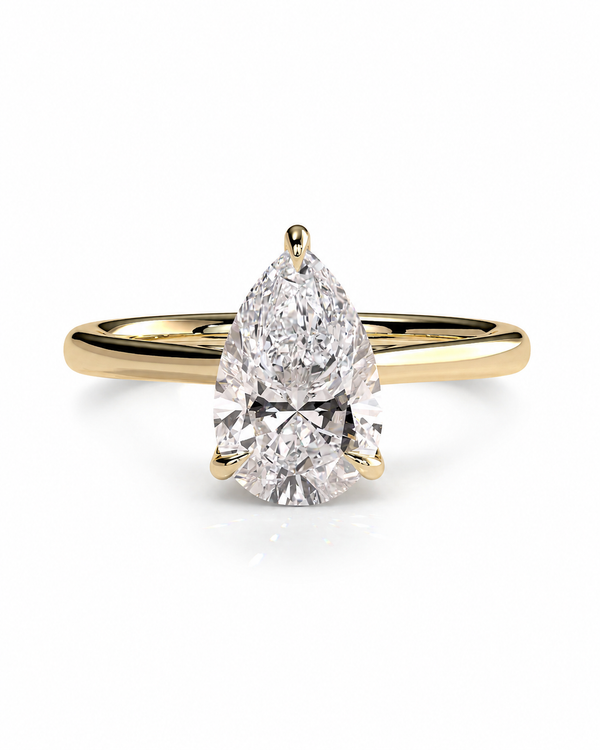 color_10K_YG, color_14K_YG &&A pear-cut diamond engagement ring with a yellow gold band, shown on a clean white background.