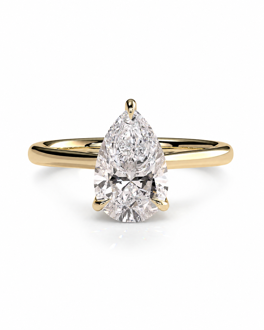 color_10K_YG, color_14K_YG &&A pear-cut diamond engagement ring with a yellow gold band, shown on a clean white background.