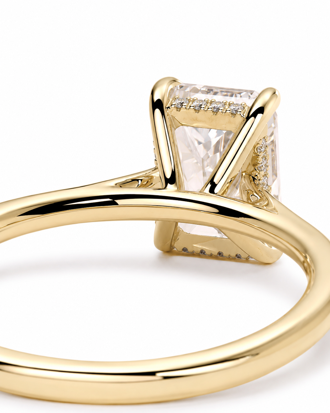 color_10K_YG, color_14K_YG &&A close-up shot of a yellow gold ring featuring a rectangular clear gemstone in a prong setting with small accent diamonds along the top, set against a plain white background.