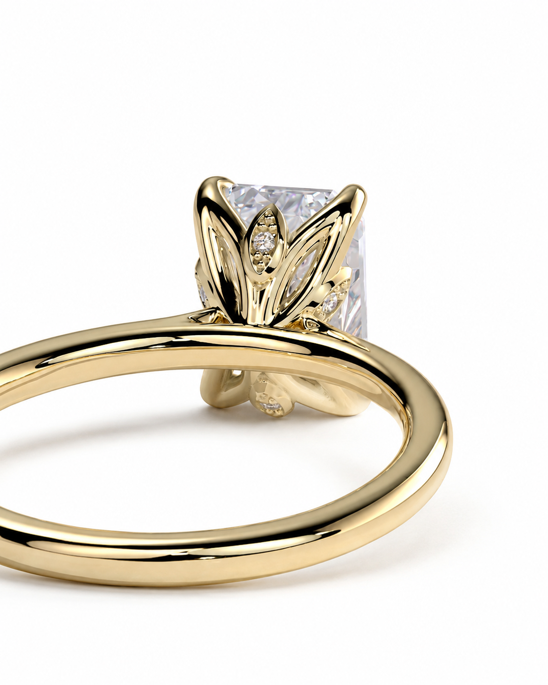 color_10K_YG, color_14K_YG &&A close-up shot of a yellow gold ring featuring a princess-cut clear center stone and small accent diamonds in a leaf-like setting, shown on a clean white background.