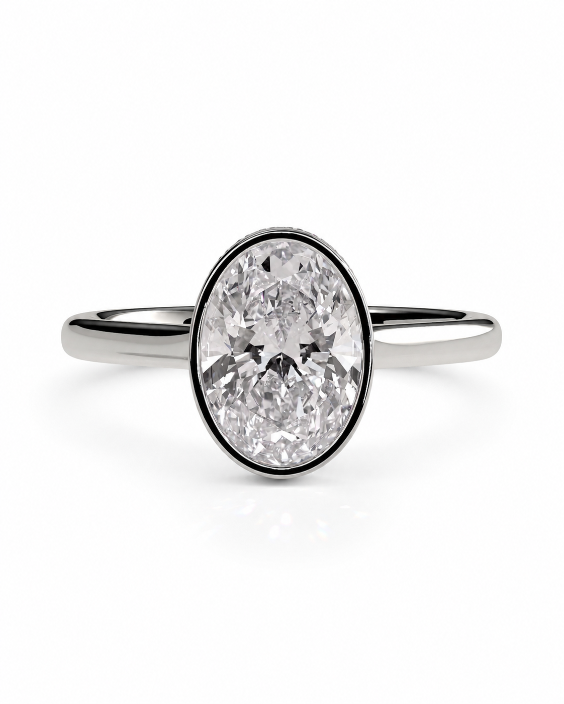 color_925_SIL,color_935_ARG,color_10K_WG, color_14K_WG &&
An oval diamond engagement ring with a brilliant-cut center stone in a bezel setting on a polished silver-colored band, shown against a plain white background.
