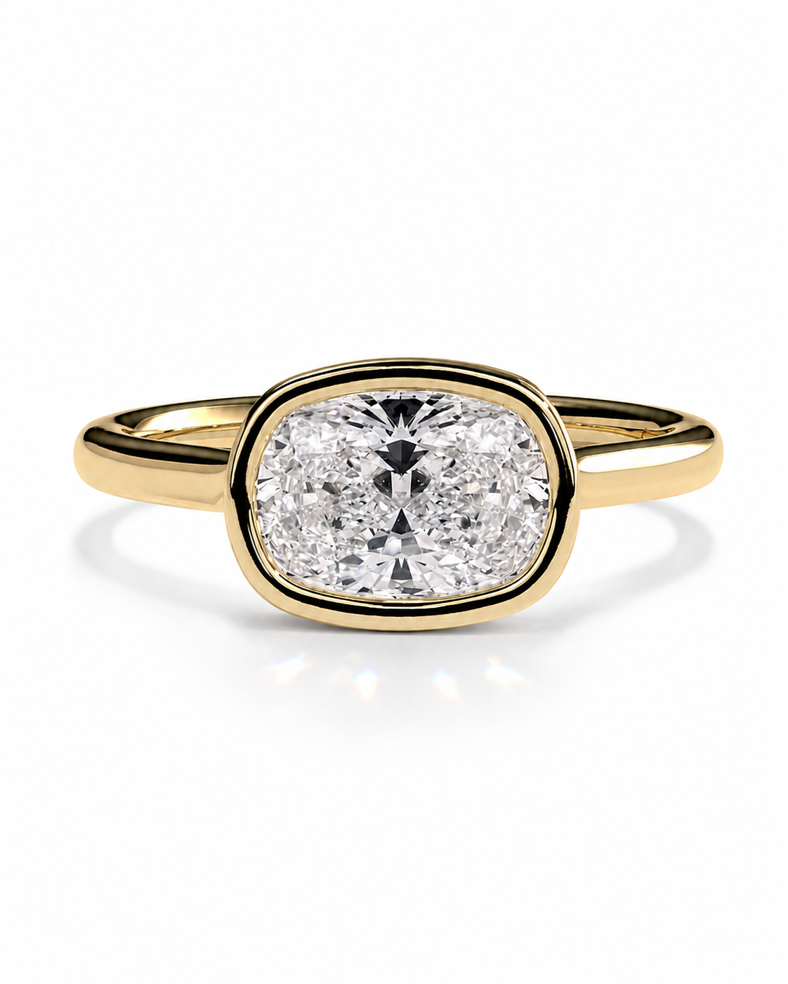 color_10K_YG, color_14K_YG &&A yellow gold ring featuring a cushion-cut diamond in an oval bezel setting, shown on a clean white background with a soft reflection.