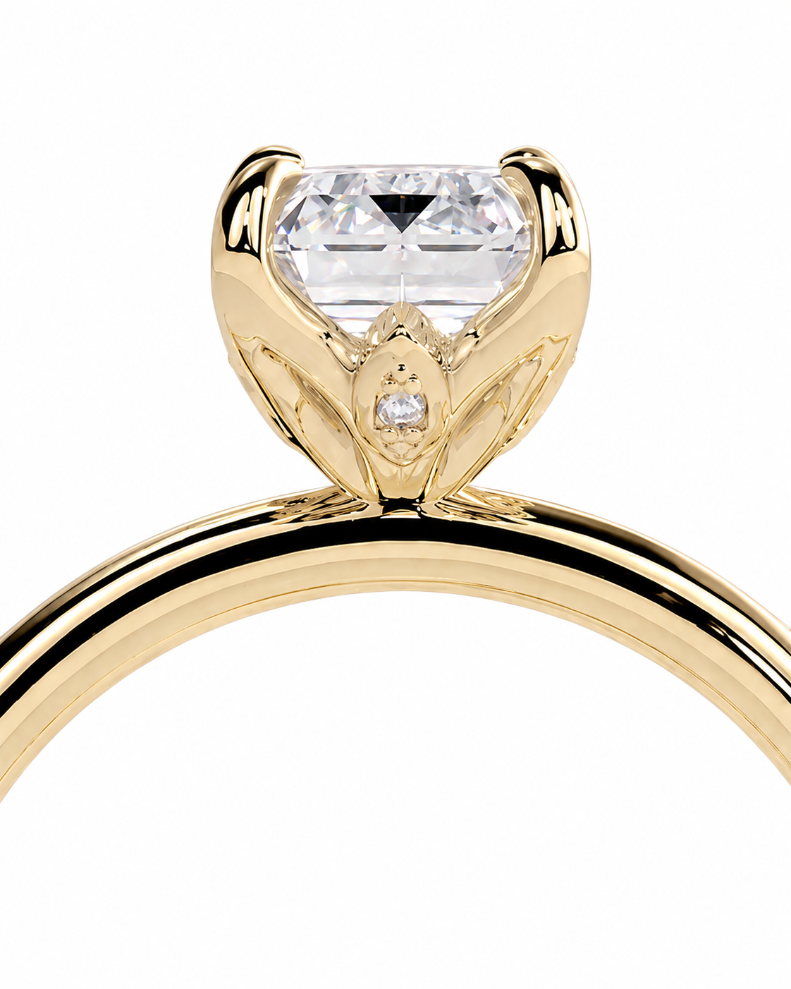 color_10K_YG, color_14K_YG &&A close-up of a yellow gold solitaire engagement ring featuring a large rectangular clear gemstone in a prong setting with a small accent diamond below it, shown against a plain white background.
