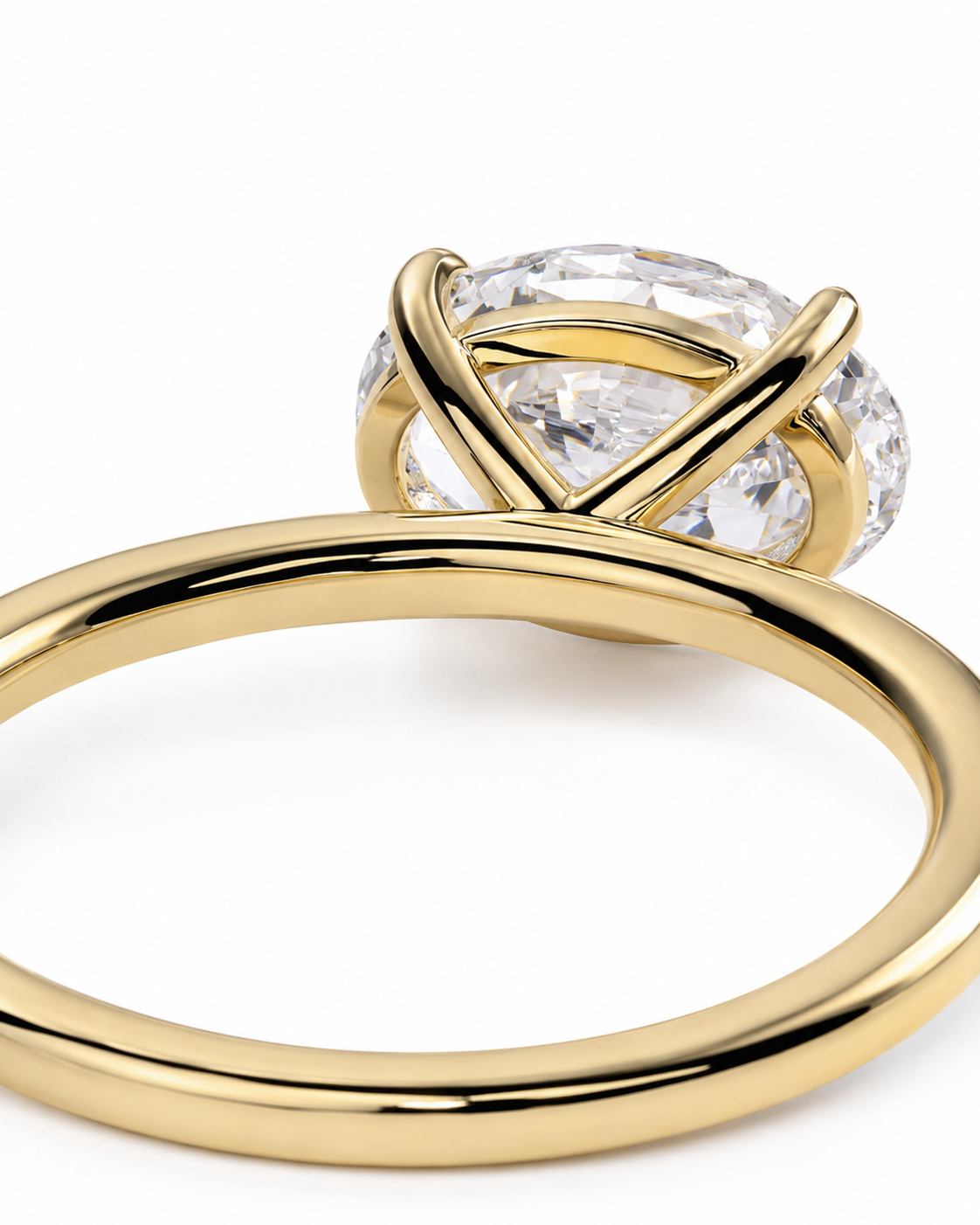 color_10K_YG, color_14K_YG &&A close-up shot of a yellow gold ring with a large, clear oval-cut gemstone in a crisscross setting, shown on a plain white background.