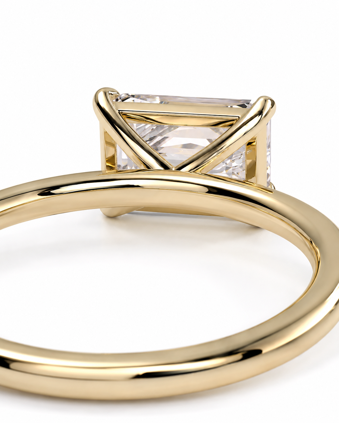 color_10K_YG, color_14K_YG &&A close-up shot of a gold ring featuring a rectangular clear gemstone in a triangular prong setting, shown against a plain white background.