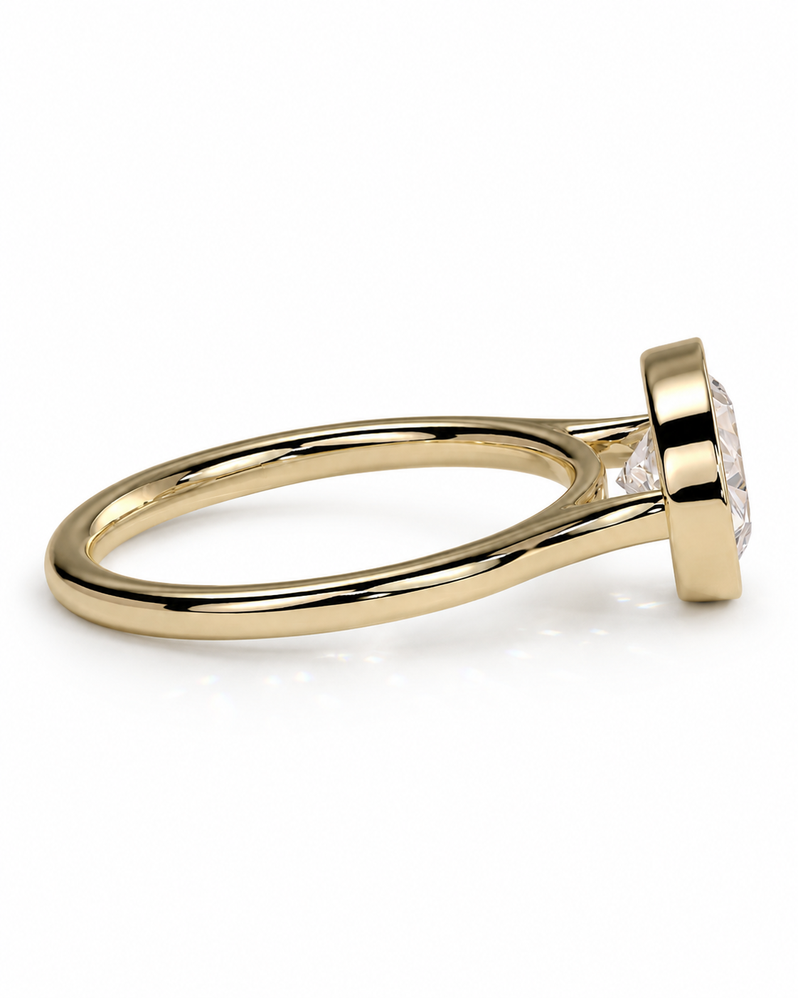 color_10K_YG, color_14K_YG &&A yellow gold solitaire engagement ring with a clear round-cut gemstone in a bezel setting, shown on a clean white background.