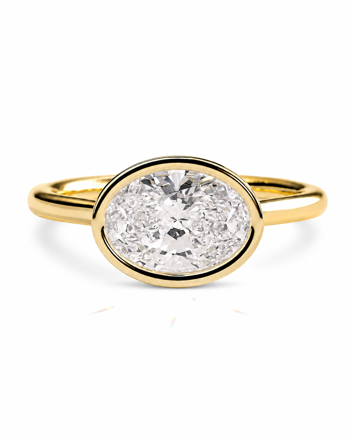 color_10K_YG, color_14K_YG &&An oval diamond engagement ring with a yellow gold band and bezel setting, shown on a clean white background.