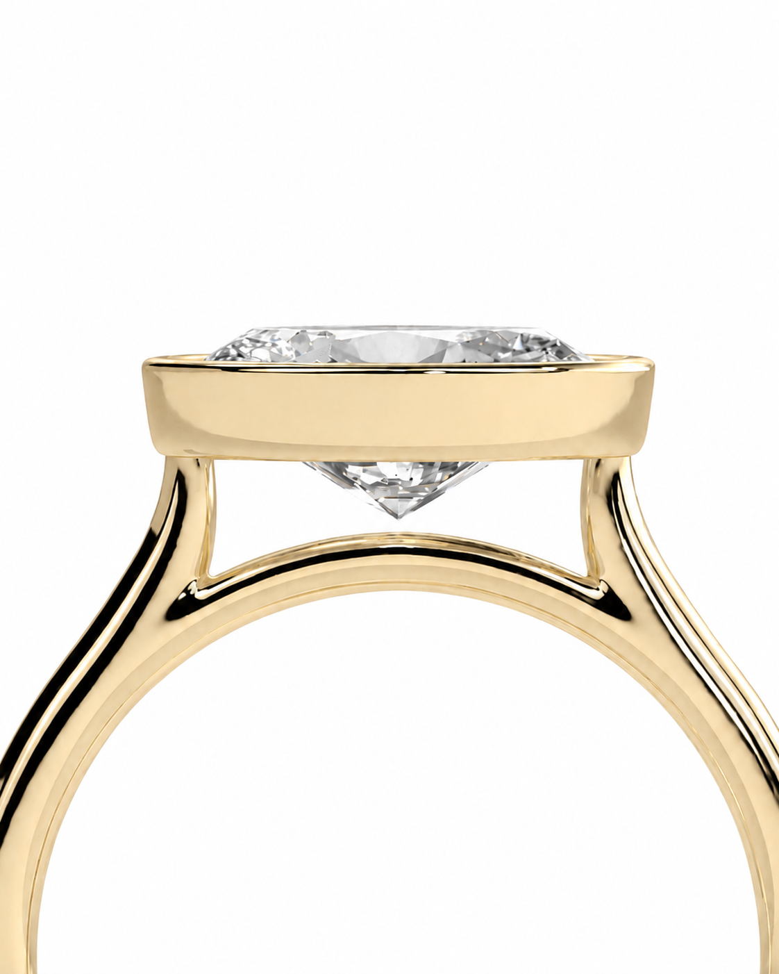color_10K_YG, color_14K_YG &&Close-up of a yellow gold ring setting with a clear round gemstone, shown against a plain white background.