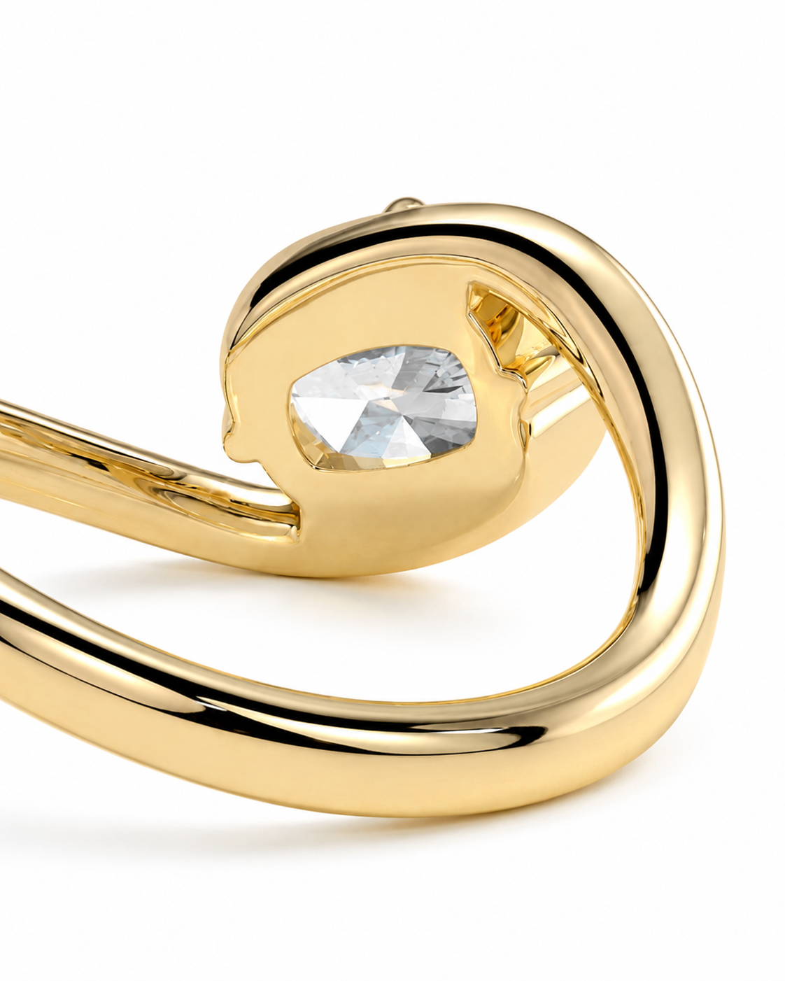 color_10K_YG, color_14K_YG &&A close-up of a gold ring featuring a curved, sculptural band with a bezel-set clear teardrop-shaped gemstone on a white background.