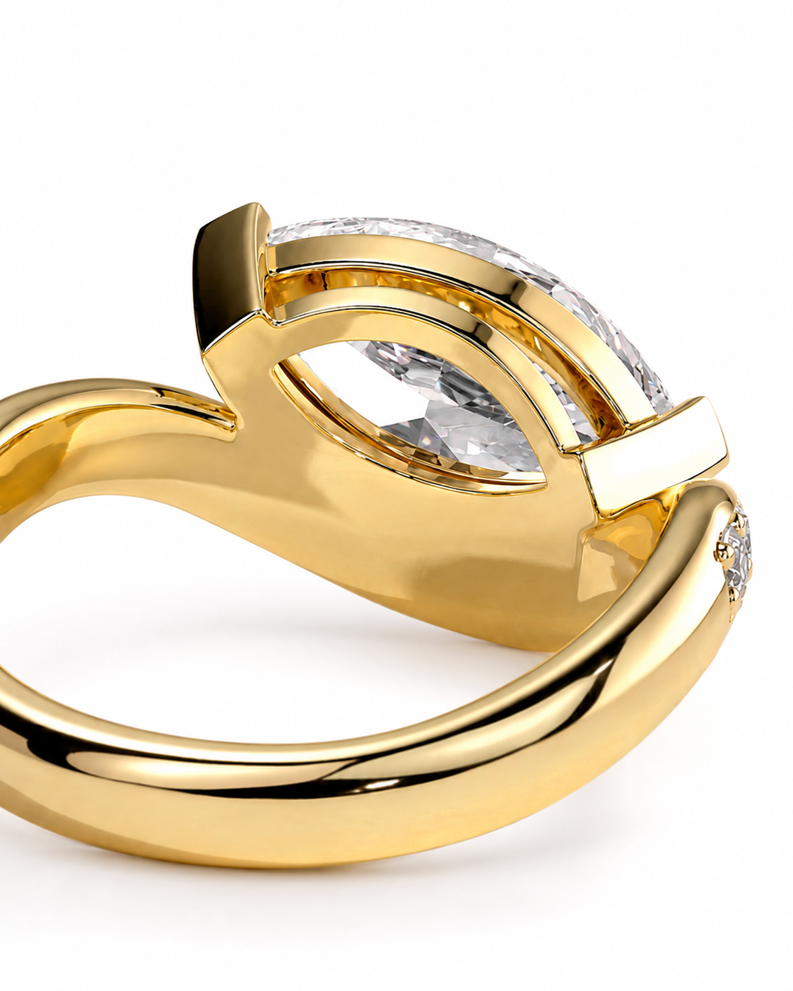 color_10K_YG, color_14K_YG &&A close-up shot of a yellow gold ring with a curved, openwork band and a large marquise-cut clear gemstone in a channel setting, shown on a white background.
