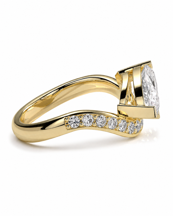 color_10K_YG, color_14K_YG &&A yellow gold ring featuring a large oval-cut clear gemstone in a prong setting, with a curved band adorned with a row of small round-cut clear gemstones, shown on a white background.