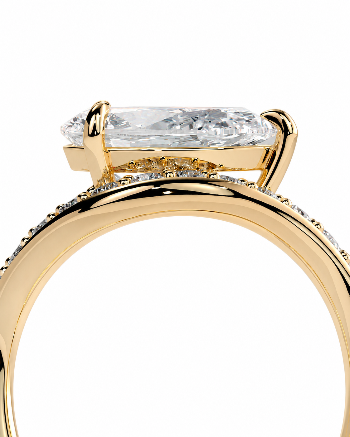 color_10K_YG, color_14K_YG &&A close-up of a yellow gold ring featuring a large rectangular cushion-cut clear gemstone in a prong setting, with a pavé band accented by small round stones, shown on a white background.