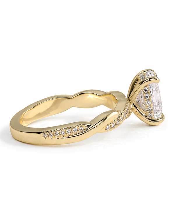 color_10K_YG, color_14K_YG &&A yellow gold engagement ring featuring a large pear-cut center stone surrounded by a halo of small clear stones, with additional pavé accents along the twisted shank, shown on a white background.