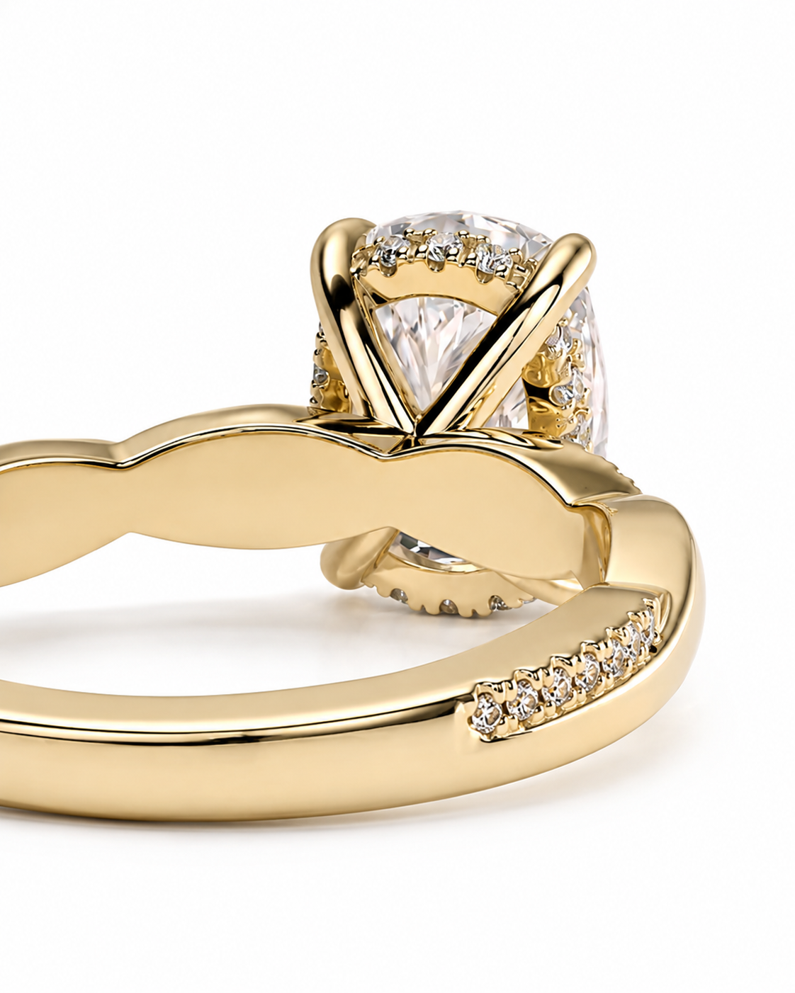 color_10K_YG, color_14K_YG &&A close-up of a yellow gold ring featuring a pear-cut center stone surrounded by a halo of small clear stones, with pavé-set accent stones along the band, shown on a white background.