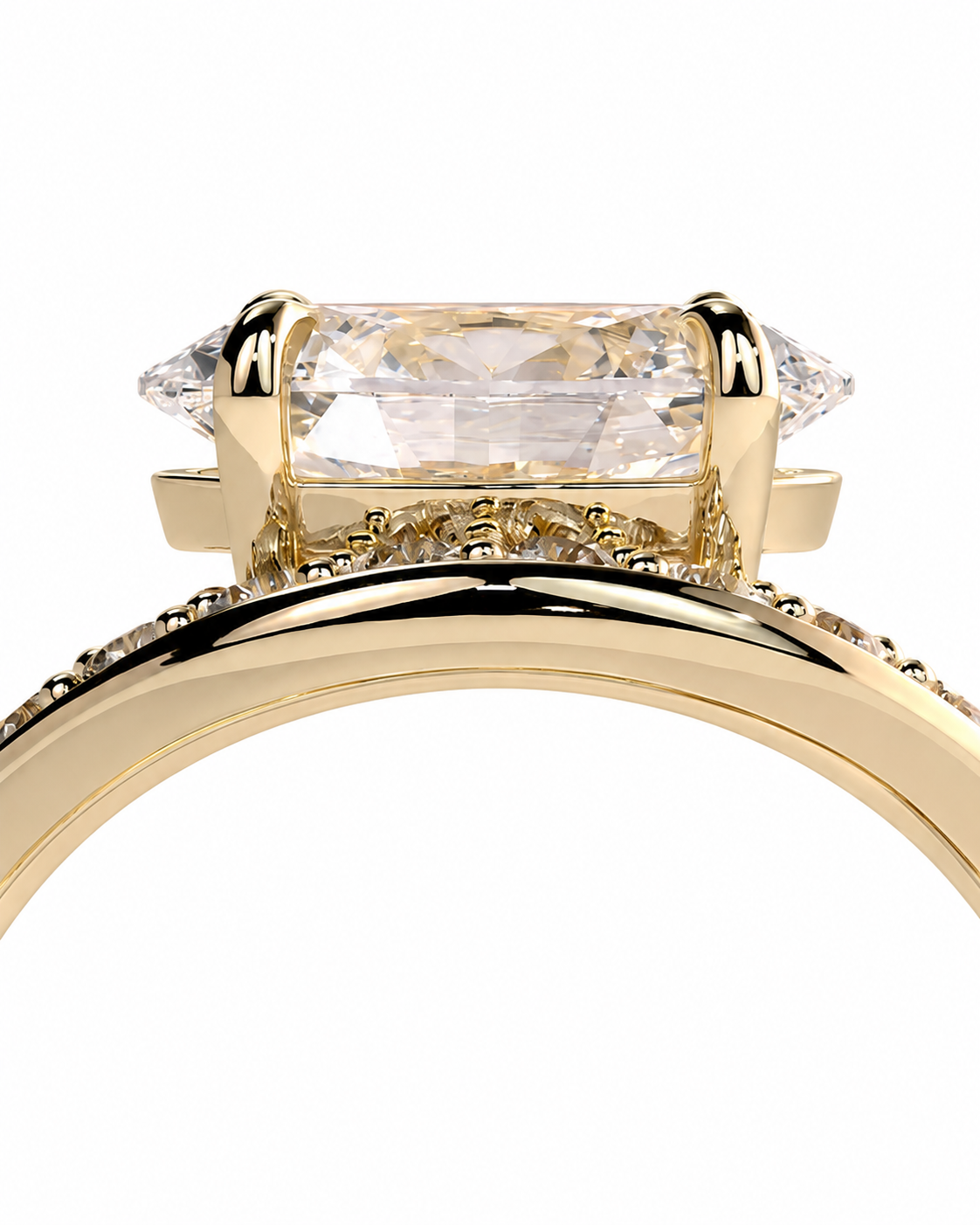color_10K_YG, color_14K_YG &&A close-up of a yellow gold ring featuring a large rectangular clear gemstone in a prong setting, with a polished band adorned with small pavé-set stones, shown against a plain white background.