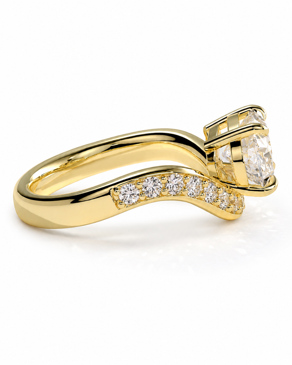 color_10K_YG, color_14K_YG &&A yellow gold split-shank engagement ring featuring a large round-cut center stone and a row of pavé diamonds along the band, set against a clean white background.