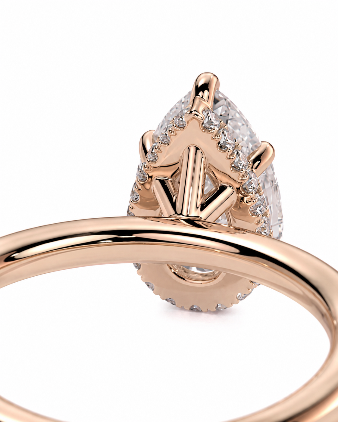 color_10K_RG, color_14K_RG &&
Close-up of a rose gold ring with a teardrop-shaped clear gemstone surrounded by small pave-set stones, shown on a white background.
