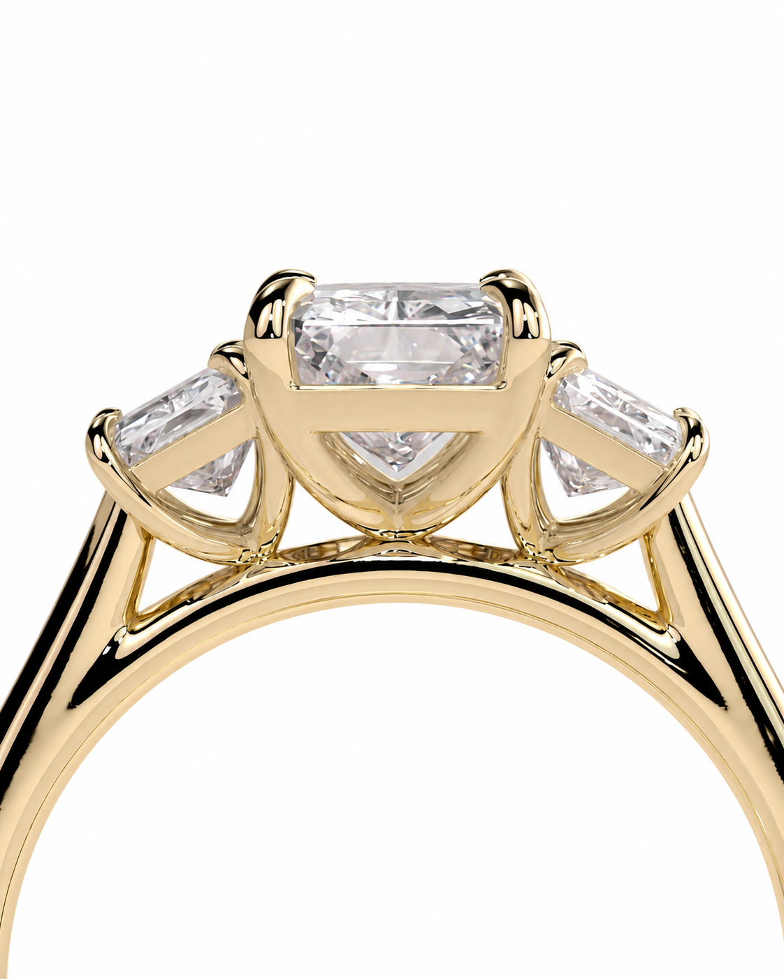 color_10K_YG, color_14K_YG &&A close-up of a yellow gold ring featuring a large rectangular center stone and two smaller baguette side stones, set against a plain white background.