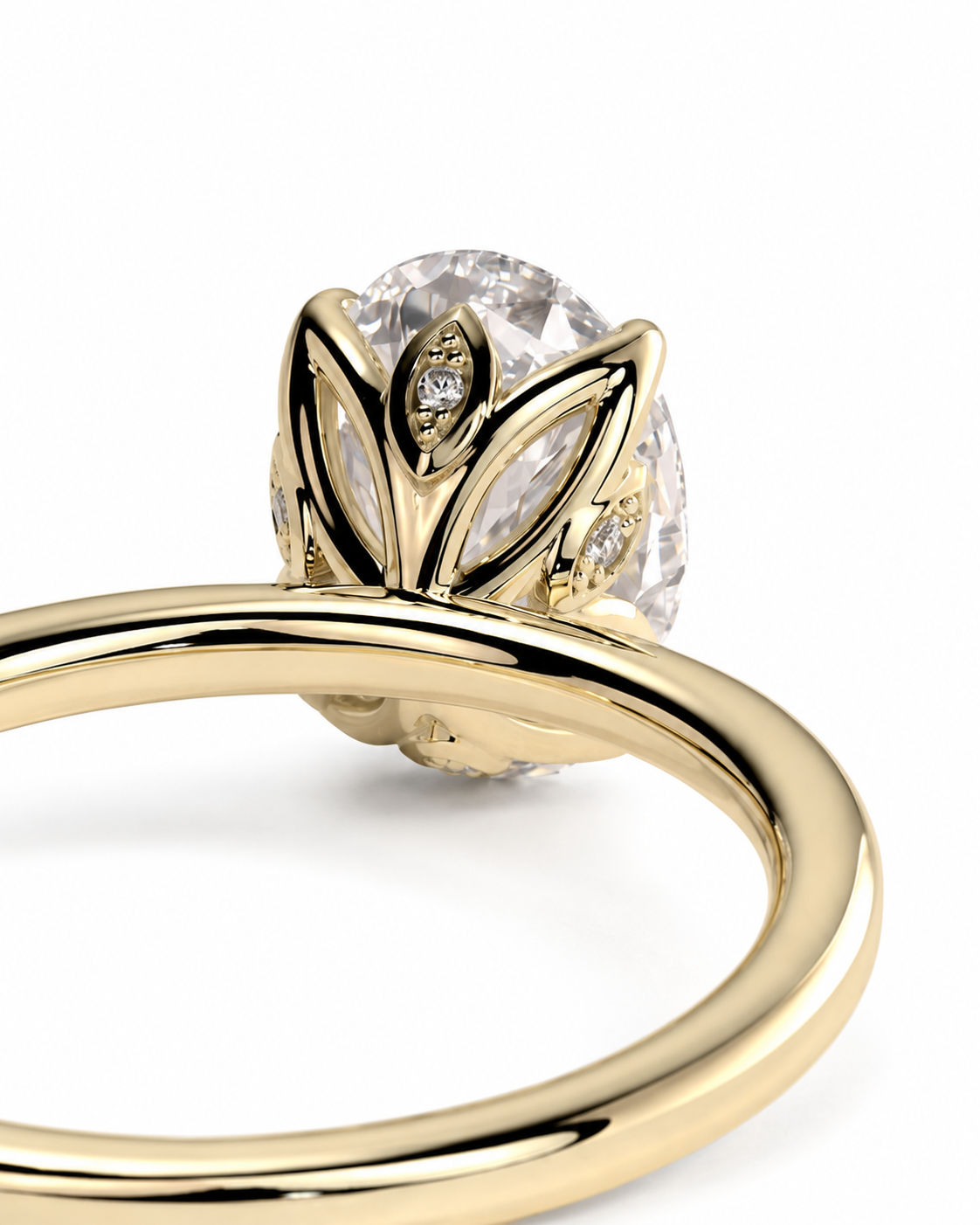 color_10K_YG, color_14K_YG &&A close-up shot of a yellow gold ring featuring a large oval clear gemstone in a leaf-like setting with small accent diamonds, on a white background.