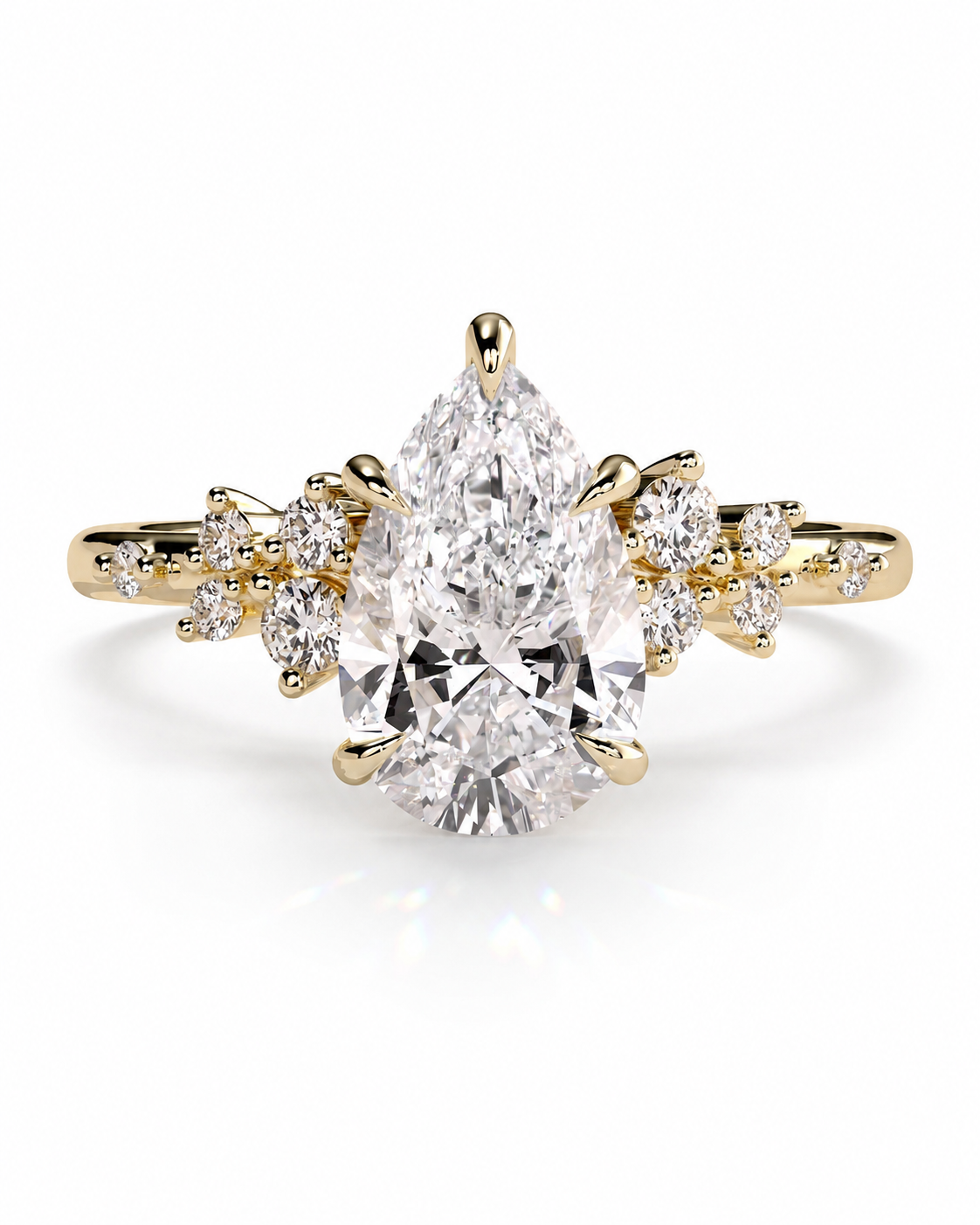 color_10K_YG, color_14K_YG &&A yellow gold ring featuring a large pear-cut diamond center stone with smaller round and marquise-cut diamonds set along the shoulders, shown on a clean white background.