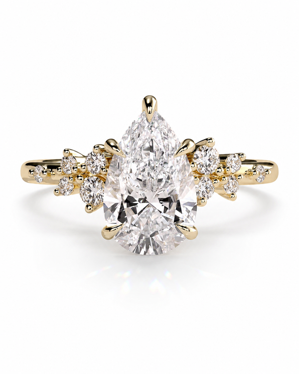 color_10K_YG, color_14K_YG &&A yellow gold ring featuring a large pear-cut diamond center stone with smaller round and marquise-cut diamonds set along the shoulders, shown on a clean white background.