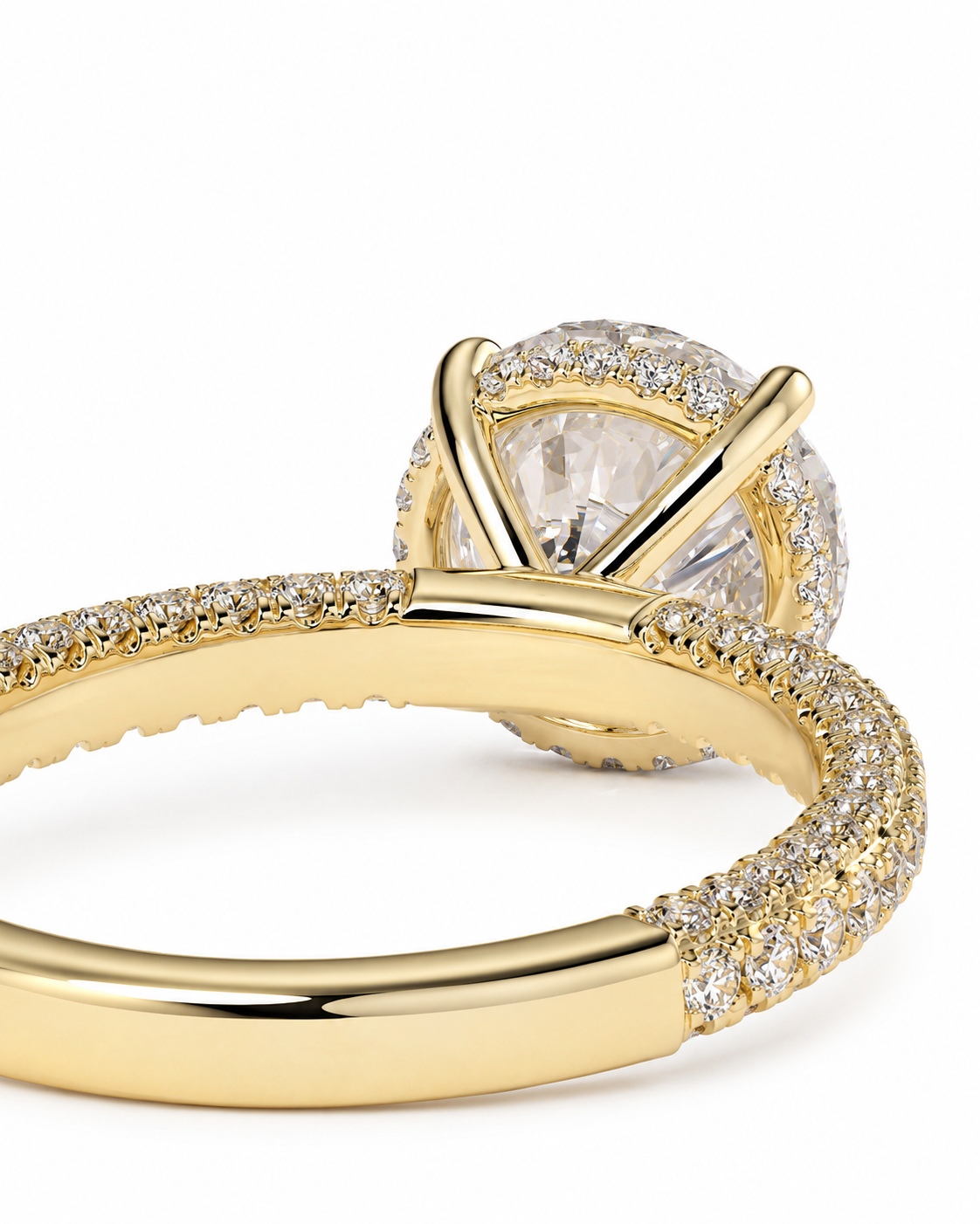 color_10K_YG, color_14K_YG &&
A close-up of a yellow gold ring featuring a large round clear center stone surrounded by a halo of small clear stones, with pave-set stones along the band.