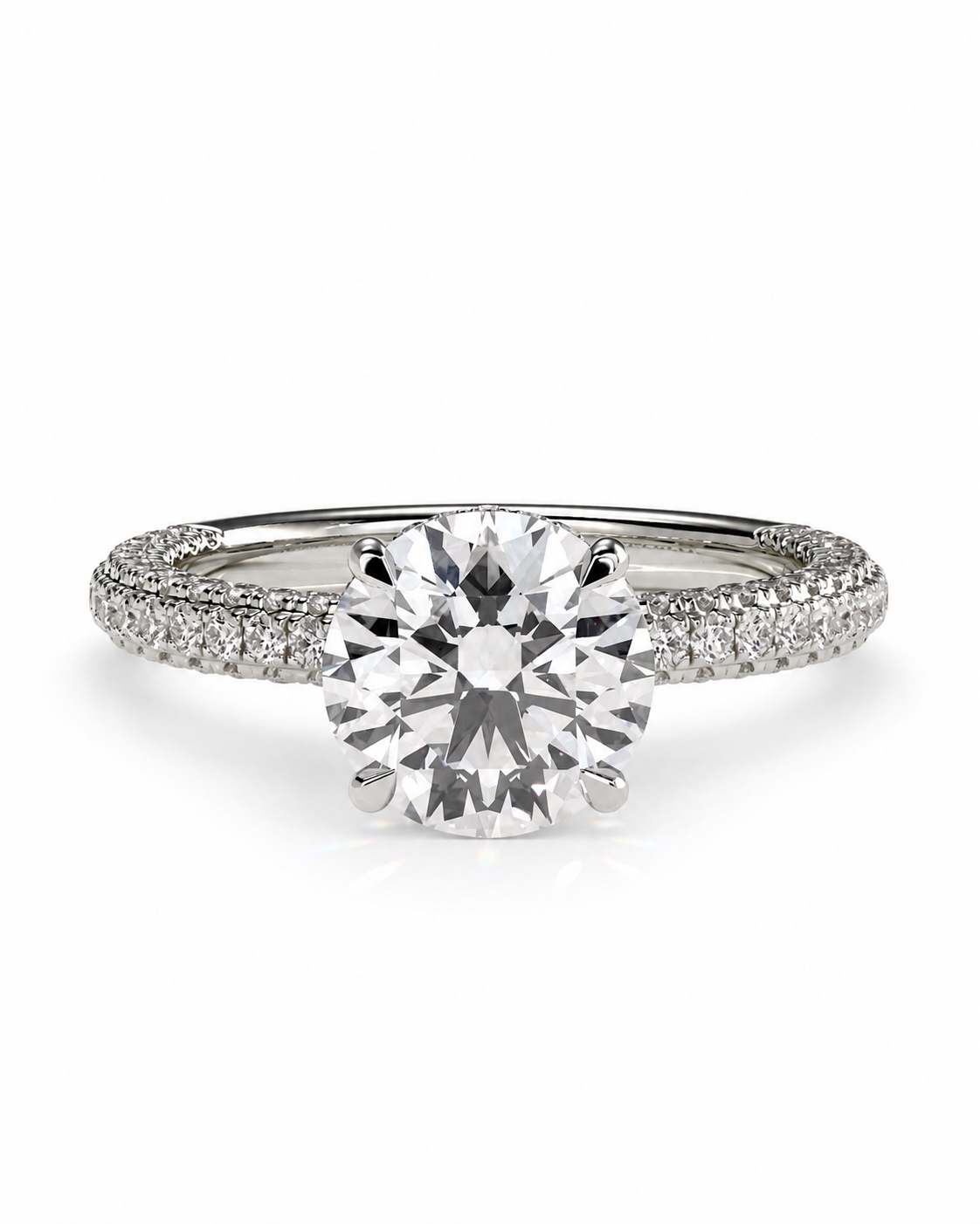 color_925_SIL,color_935_ARG,color_10K_WG, color_14K_WG &&
A classic solitaire engagement ring featuring a round brilliant-cut center stone in a six-prong setting, with a pave band set with small round stones, shown on a clean white background.