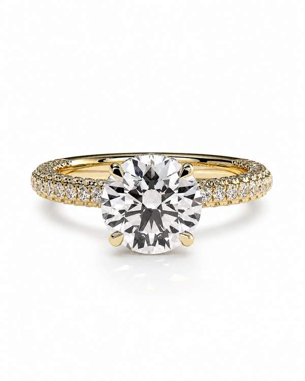 color_10K_YG, color_14K_YG &&
A yellow gold solitaire engagement ring featuring a round brilliant-cut center stone and pave-set accent stones along the shoulders, shown on a clean white background.