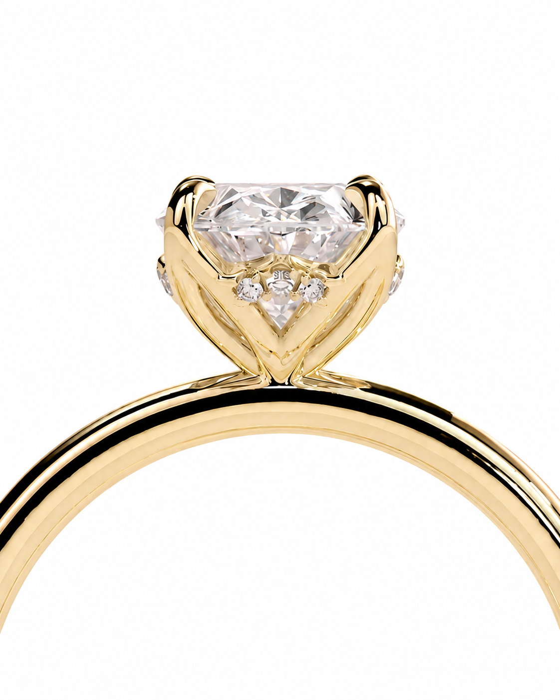 color_10K_YG, color_14K_YG &&A close-up of a yellow gold solitaire engagement ring featuring a heart-shaped clear gemstone in a prong setting with small accent diamonds on the band, set against a plain white background.