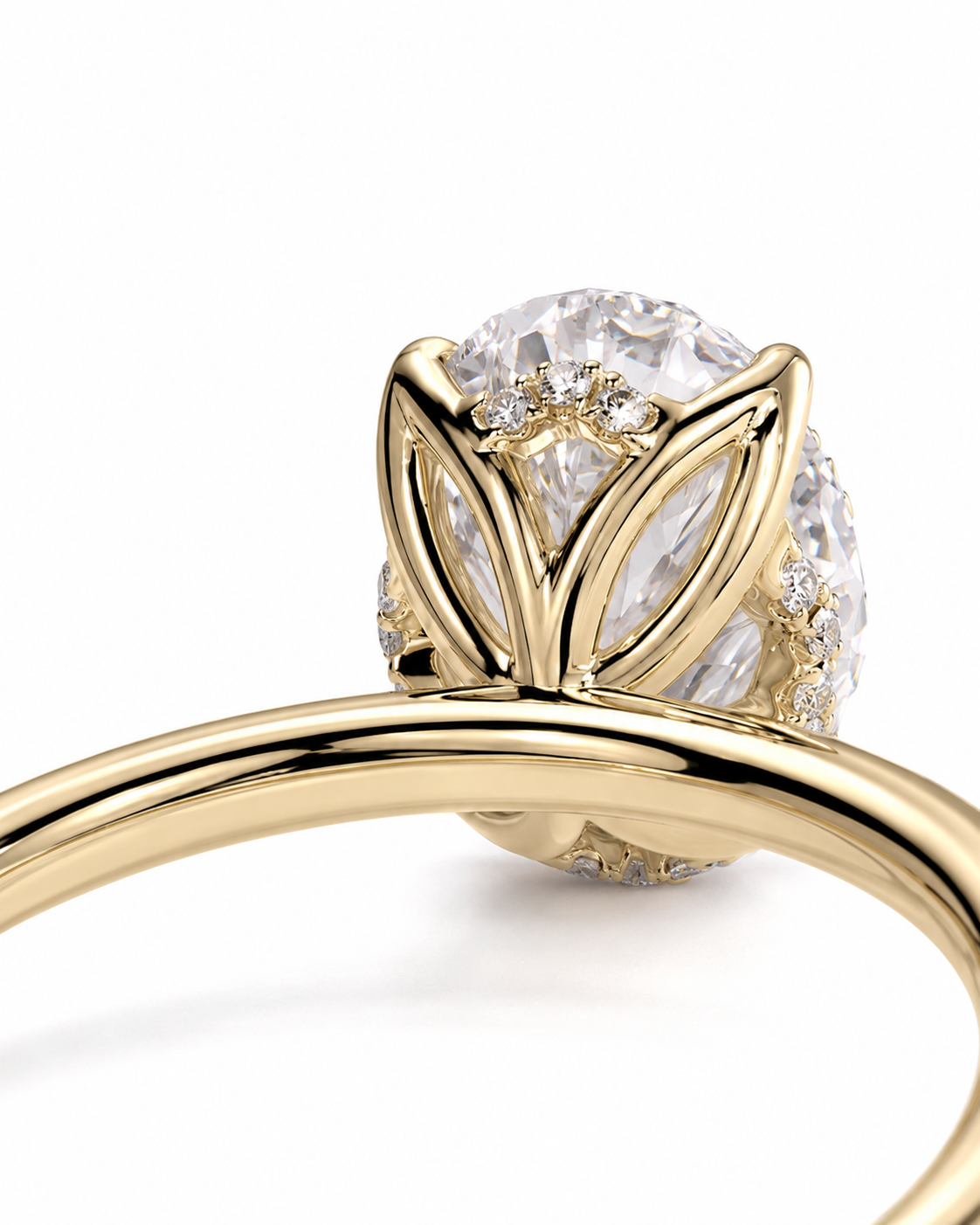 color_10K_YG, color_14K_YG &&A close-up of a yellow gold ring featuring a large oval clear gemstone in a leaf-like setting, with smaller accent stones along the sides, photographed on a clean white background.