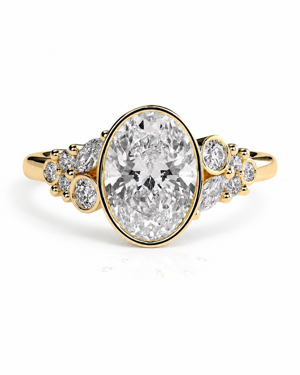 color_10K_YG, color_14K_YG &&A yellow gold ring featuring a large oval-cut clear center stone, flanked by smaller round and marquise-cut stones on both sides, set against a plain white background.