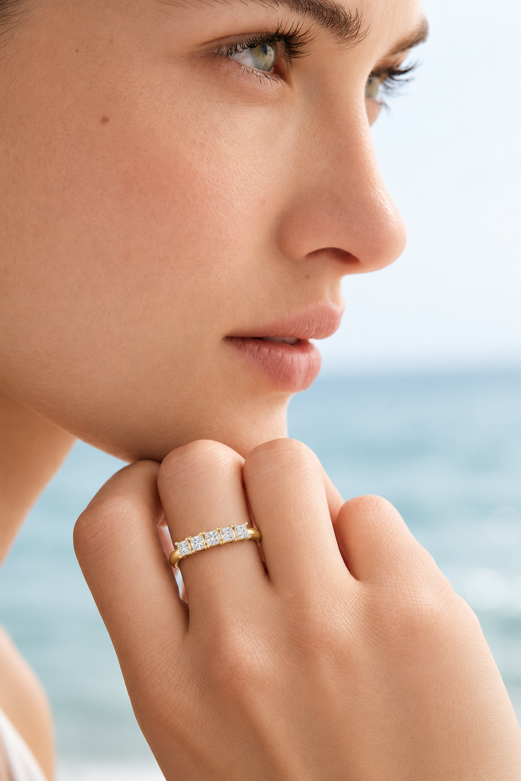 color_10K_YG, color_14K_YG &&Close-up view of a women's wedding band featuring brilliant near colorless Moissanite stones in a structured setting