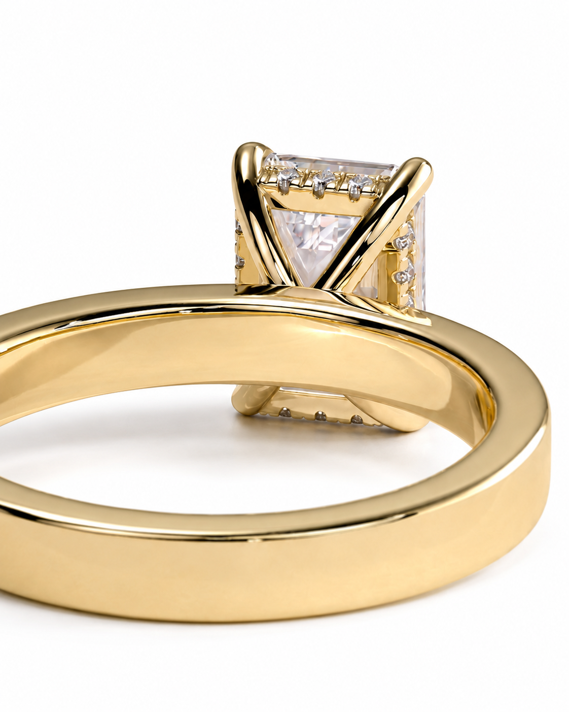 color_10K_YG, color_14K_YG &&A close-up shot of a yellow gold ring featuring a square-cut clear gemstone in a prong setting with small accent diamonds along the band, set against a plain white background.