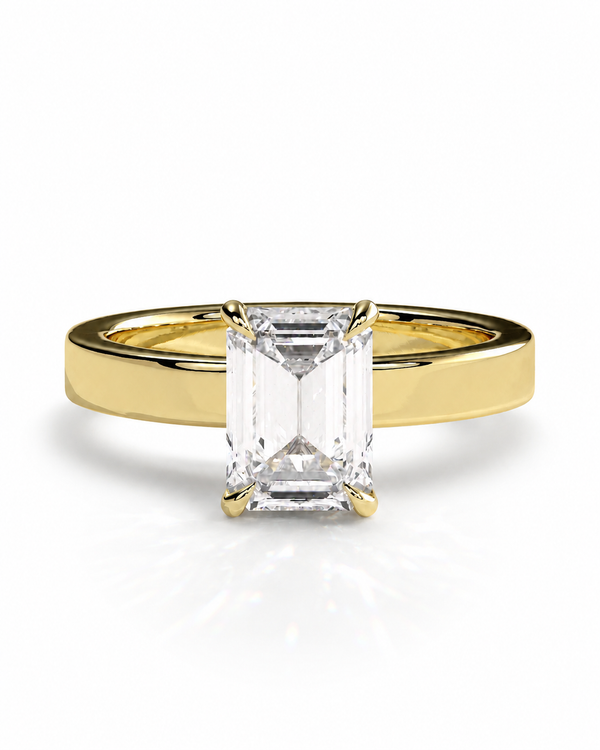 color_10K_YG, color_14K_YG &&A yellow gold solitaire engagement ring featuring a large rectangular emerald-cut clear center stone, set against a clean white background with a soft reflection.