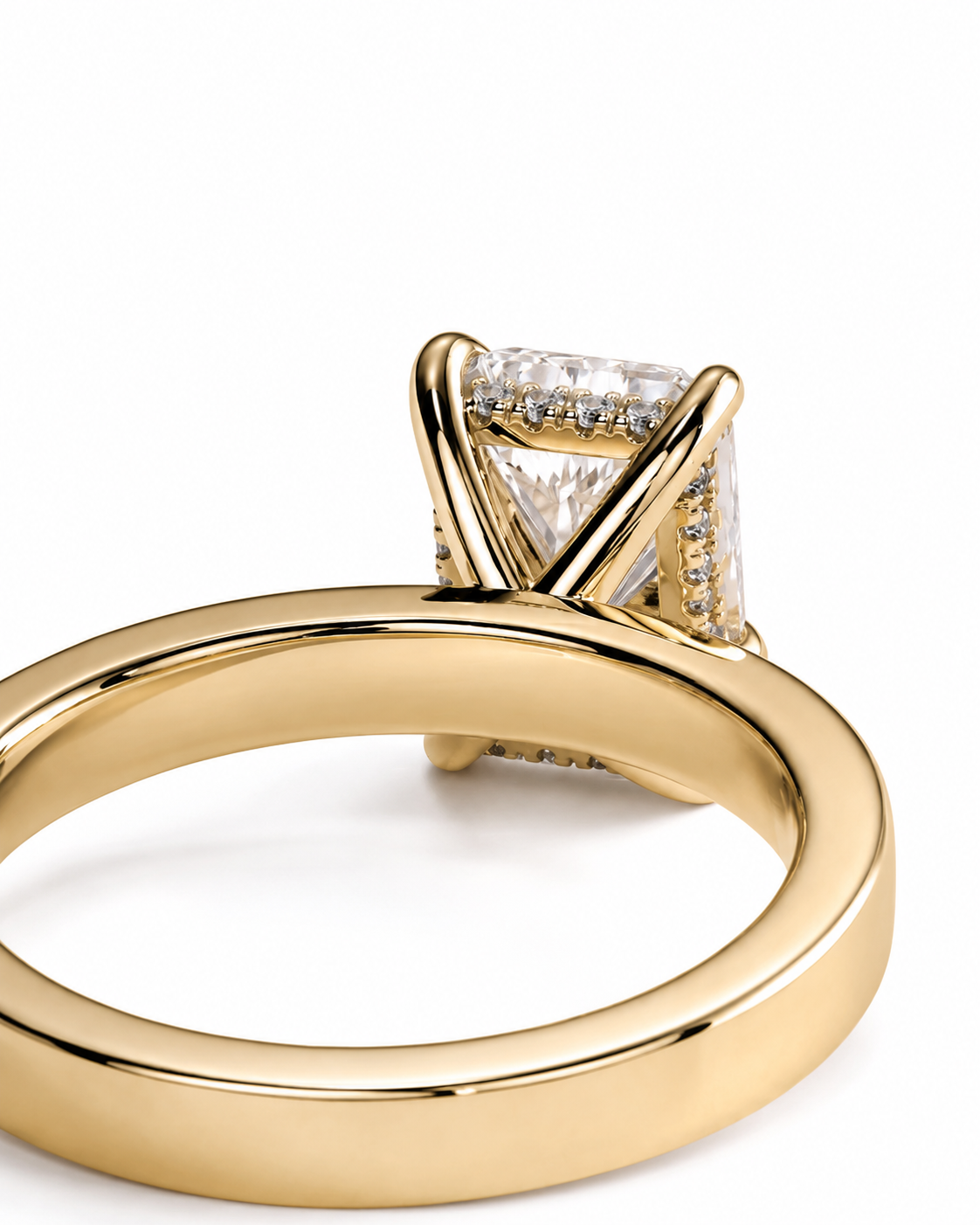 color_10K_YG, color_14K_YG &&A close-up shot of a yellow gold ring featuring a triangular-cut clear gemstone in a prong setting with small accent stones along the band, set against a plain white background.
