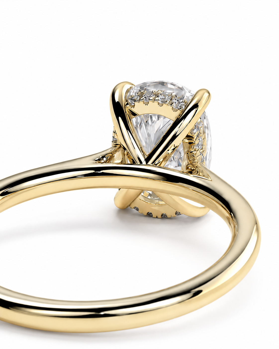 color_10K_YG, color_14K_YG &&A close-up of a yellow gold solitaire ring featuring a large oval-cut clear gemstone in a prong setting, with a halo of smaller diamonds along the top, on a clean white background.