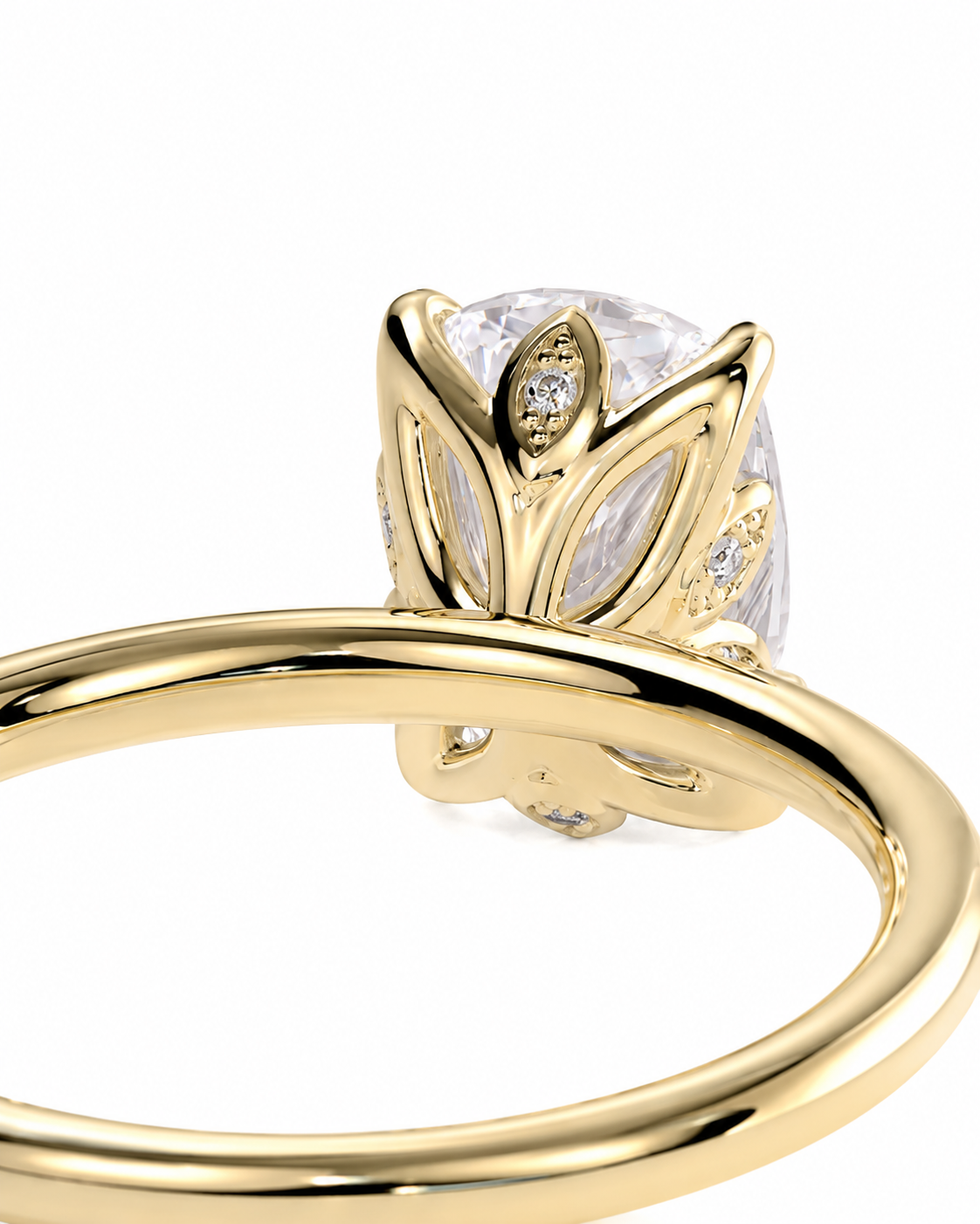 color_10K_YG, color_14K_YG &&A close-up of a yellow gold ring featuring a large oval clear gemstone in a leaf-like setting with small accent diamonds, shown on a plain white background.