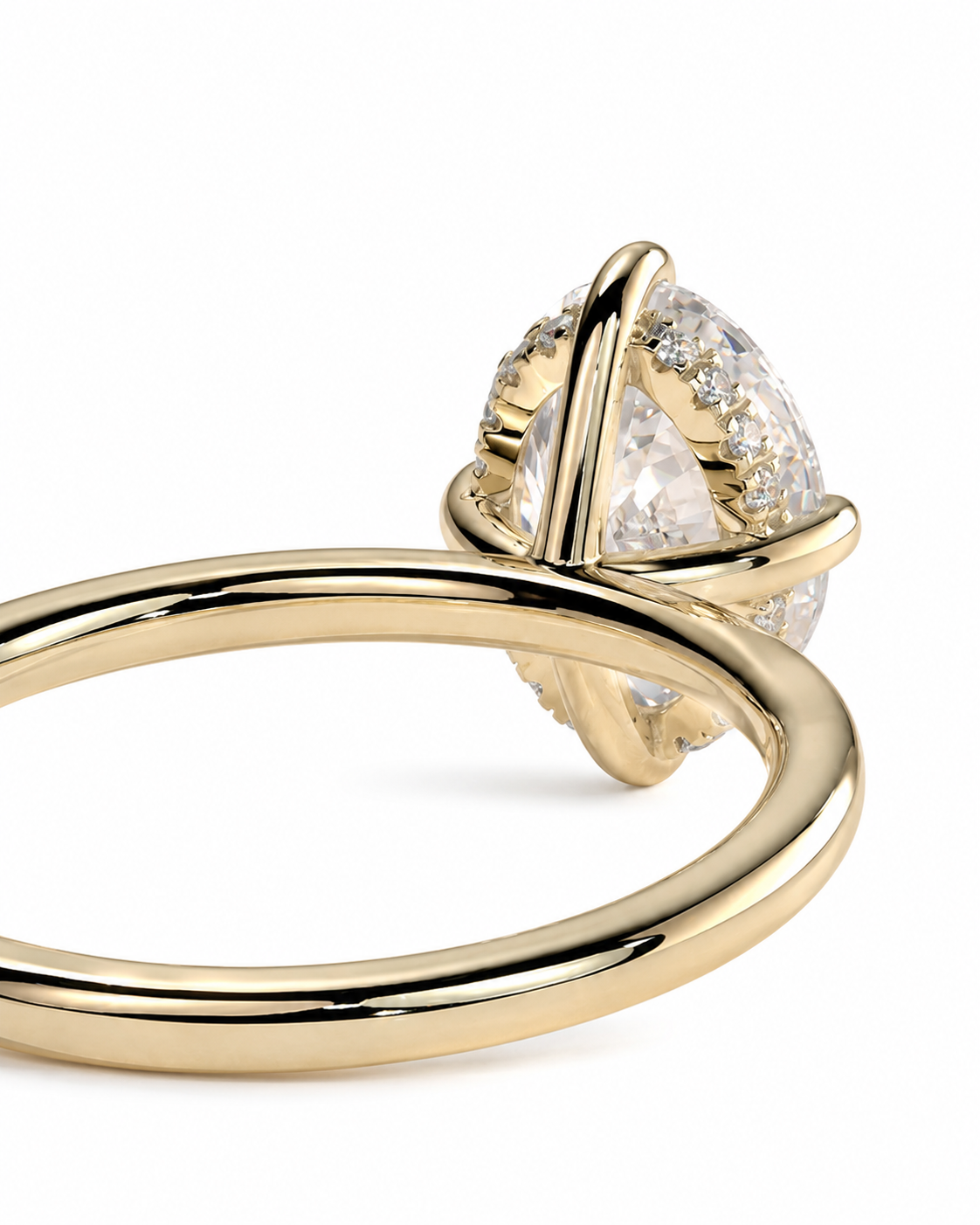 color_10K_YG, color_14K_YG &&A close-up of a gold ring featuring a pear-cut clear center stone with small accent stones, shown on a clean white background.